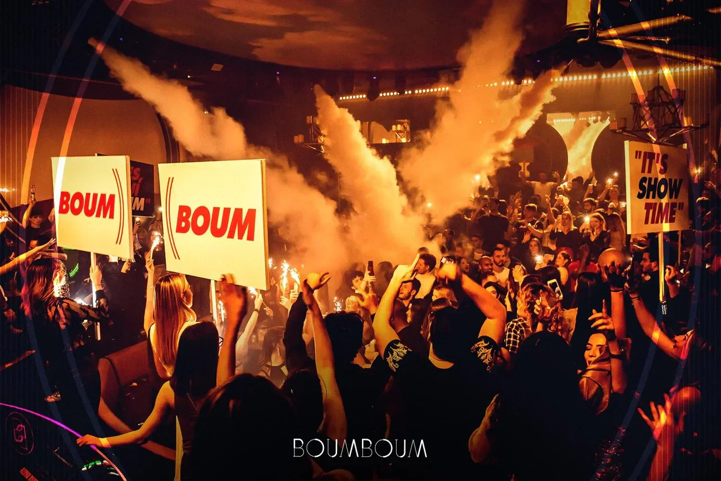 Boum Boum nightclub in Paris with a vibrant crowd and 'It's show time' signs