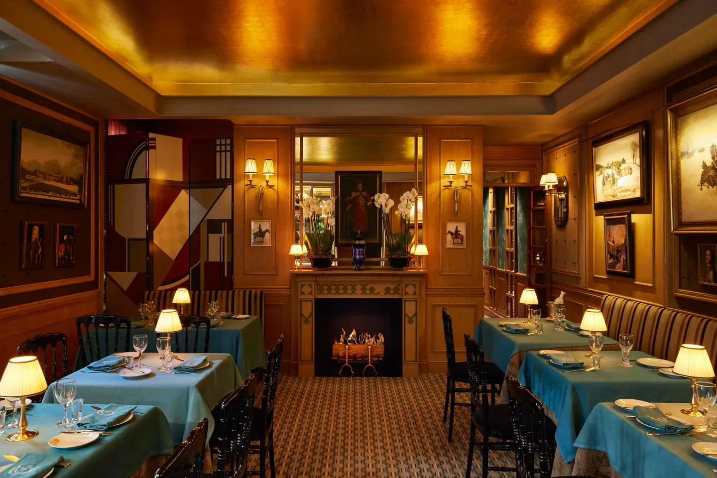 Elegant dining room at Caviar Kaspia in Paris, featuring a fireplace and art.