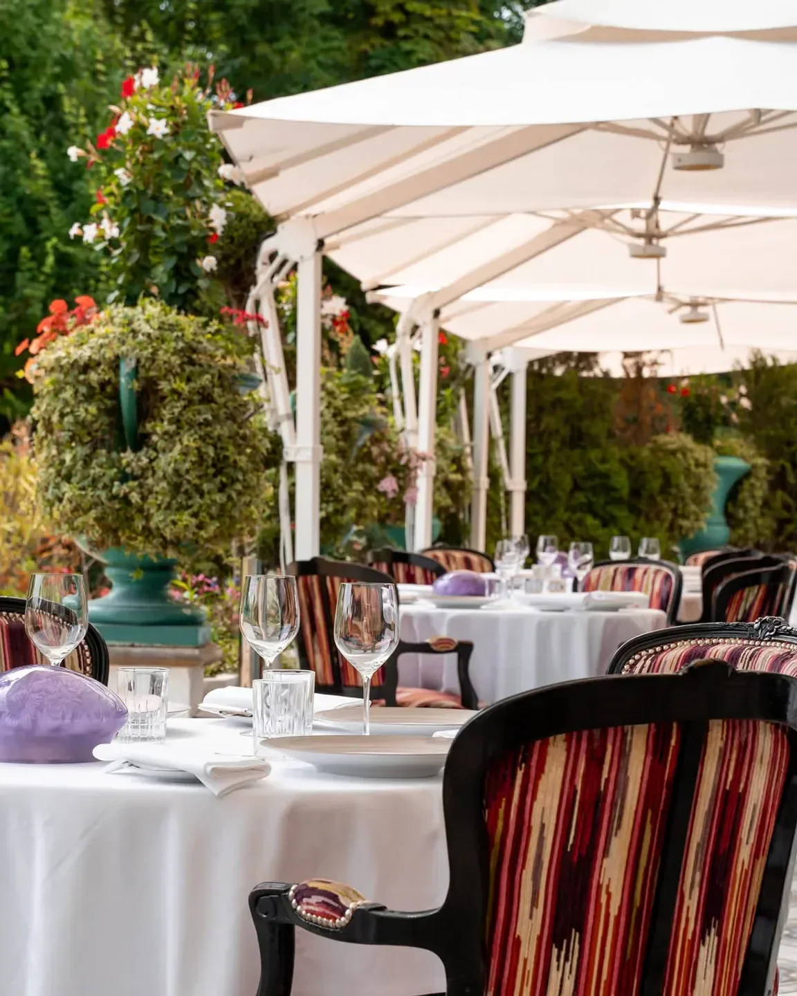 Outdoor dining at La Grande Cascade restaurant in Paris, featuring elegant table setting.