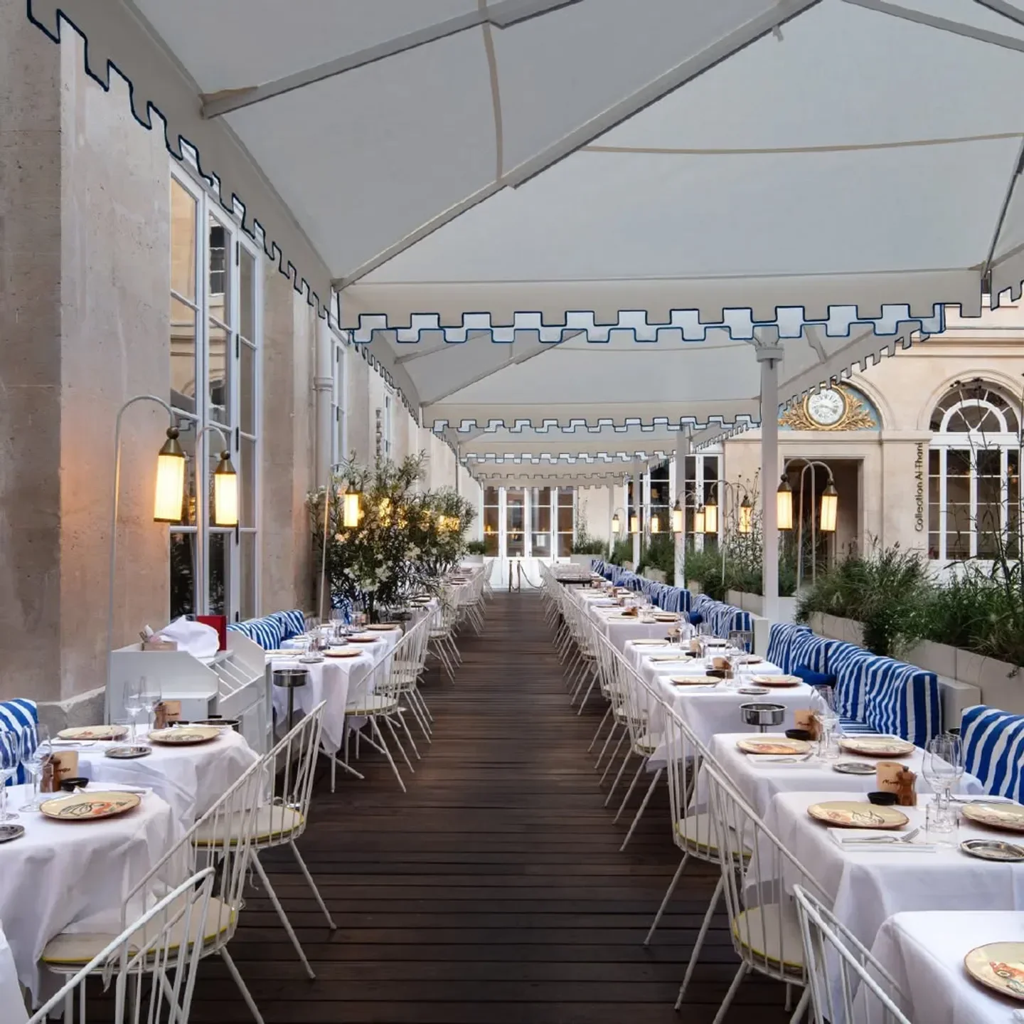 Elegant outdoor dining at Mimosa restaurant in Paris with long table settings.